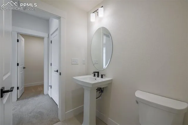 a bathroom with a sink mirror and toilet
