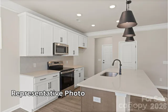 a kitchen with stainless steel appliances a microwave a stove and a refrigerator