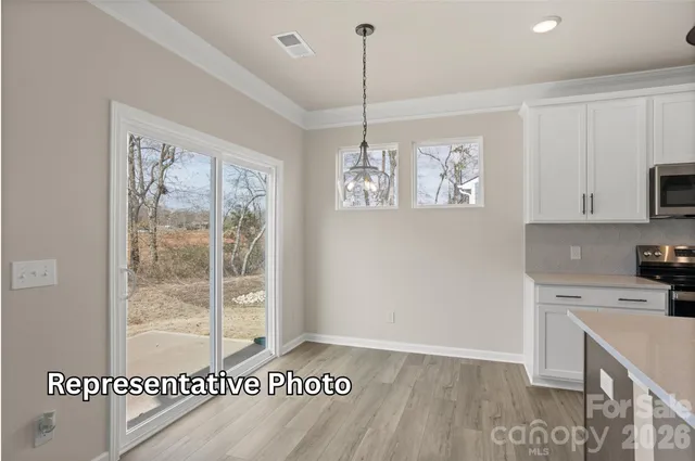 a view of a kitchen with a sink wooden floor and a chandelier