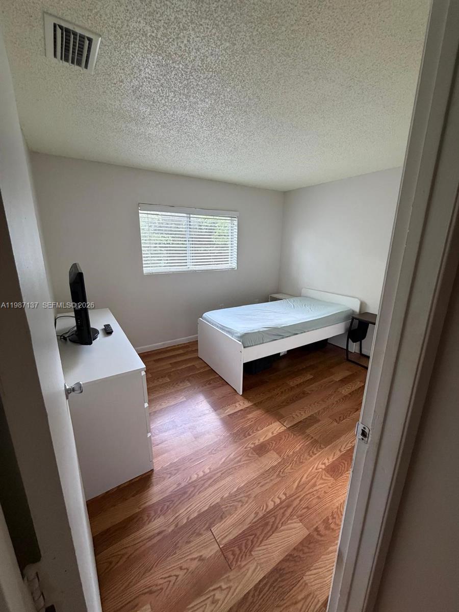 8240 Southwest 149th Court, Unit 7202 Miami, FL 33193 - Photo 11 of 11 a bedroom with a bed and a window