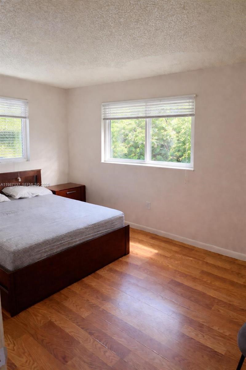 8240 Southwest 149th Court, Unit 7202 Miami, FL 33193 - Photo 6 of 11 a bedroom with a bed and window
