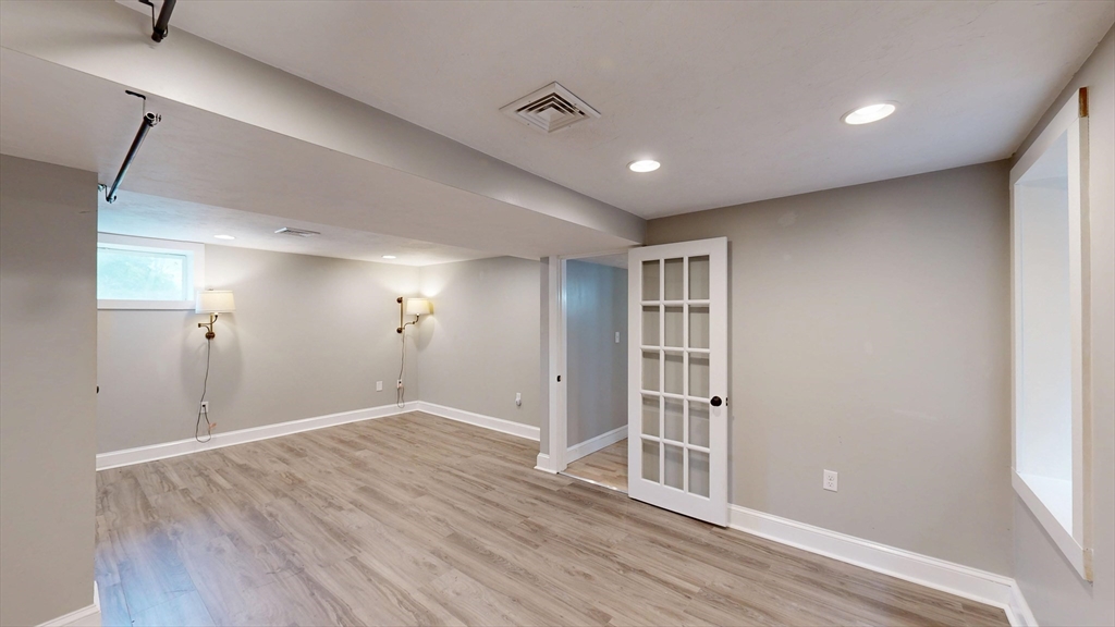 15 Slab Bridge Road Freetown, MA 02702 - Photo 24 of 39 a view of empty room with wooden floor and windows