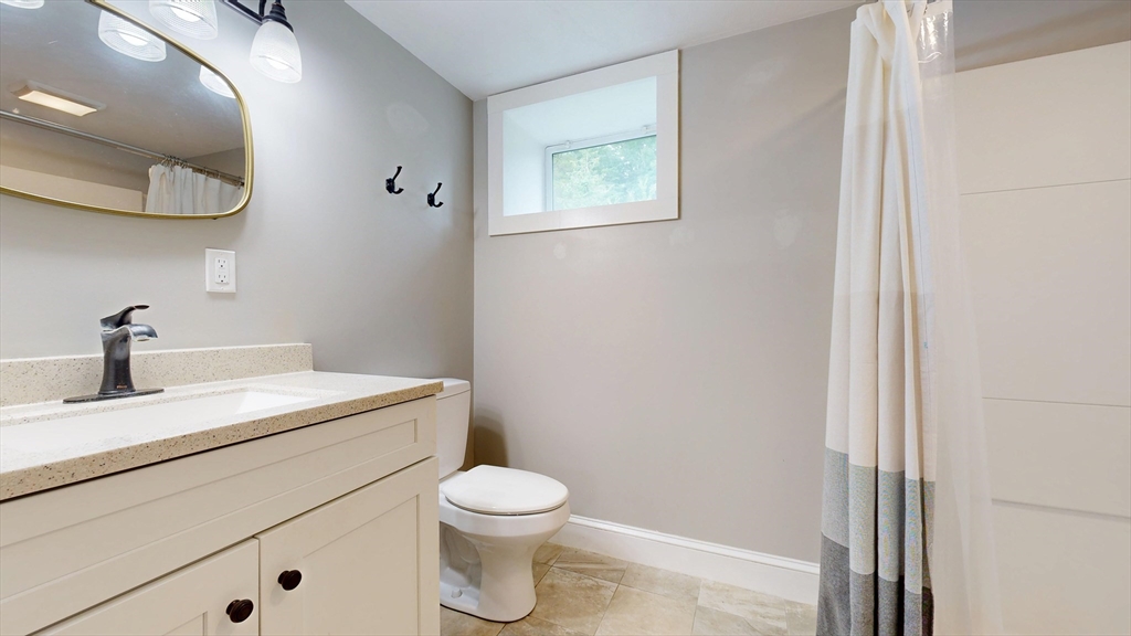 15 Slab Bridge Road Freetown, MA 02702 - Photo 25 of 39 a bathroom with a toilet a sink and mirror