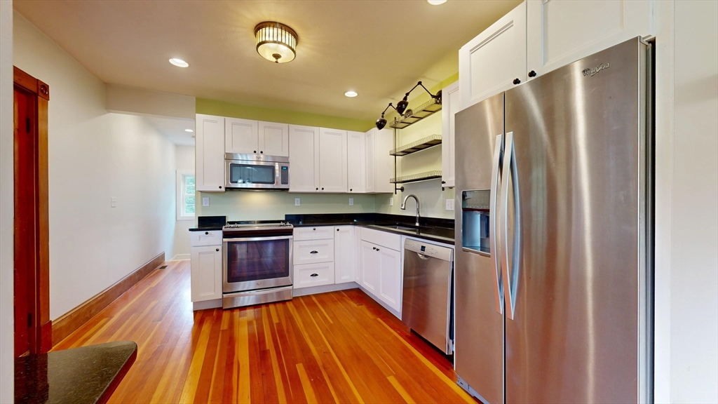 15 Slab Bridge Road Freetown, MA 02702 - Photo 8 of 39 a kitchen with stainless steel appliances granite countertop a refrigerator a sink dishwasher a stove and white countertops with wooden floor