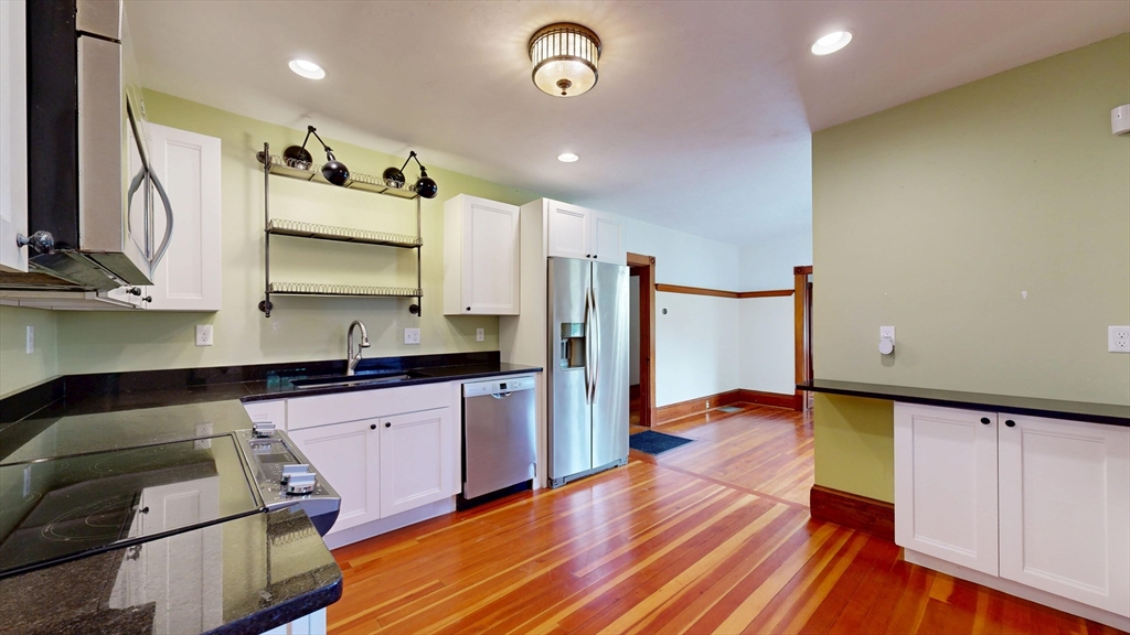 15 Slab Bridge Road Freetown, MA 02702 - Photo 10 of 39 a kitchen with stainless steel appliances granite countertop a refrigerator a sink dishwasher and a stove with wooden floor