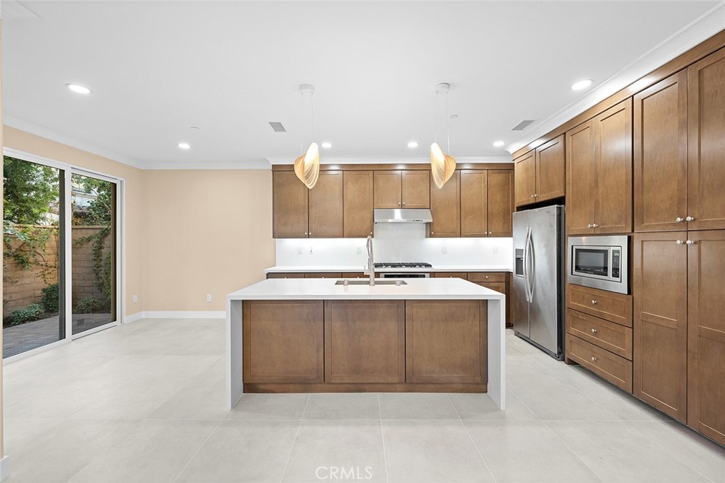 143 Rodeo Irvine, CA 92602 - Photo 3 of 37 a kitchen with stainless steel appliances a stove and a refrigerator