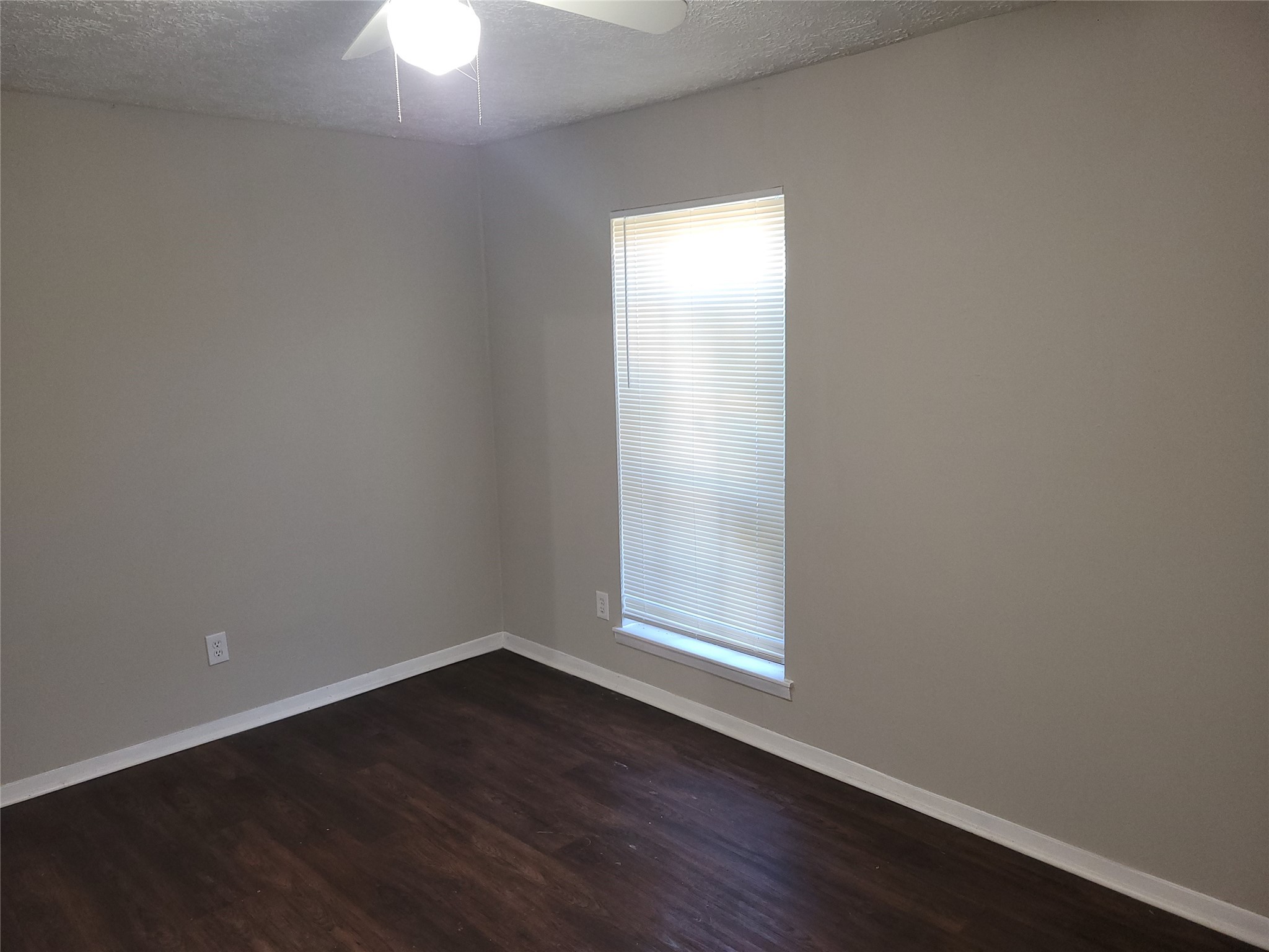 15810 Boonridge Road Houston, TX 77053 - Photo 13 of 15 an empty room with wooden floor fan and windows