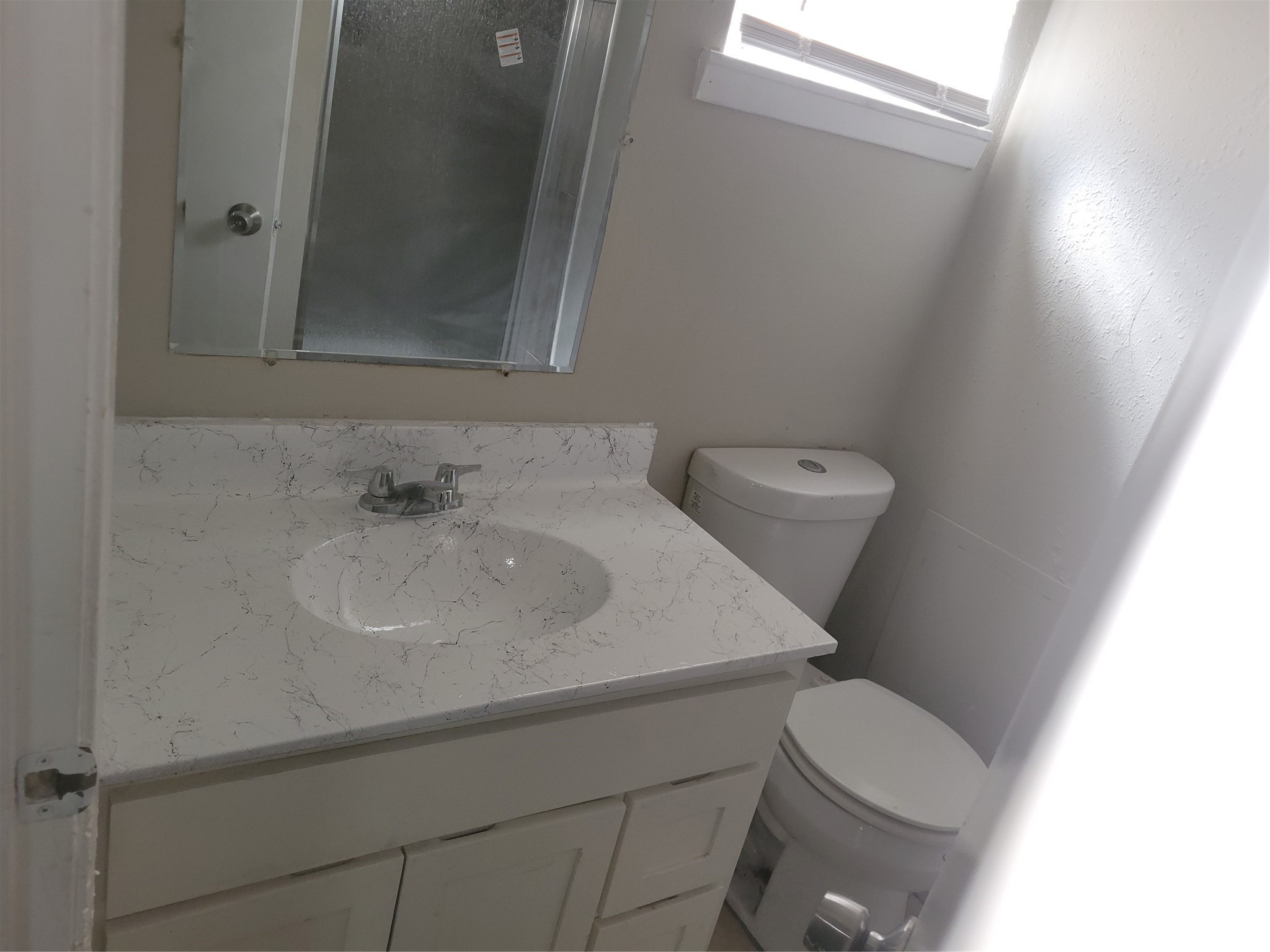 15810 Boonridge Road Houston, TX 77053 - Photo 14 of 15 a bathroom with a toilet sink and mirror