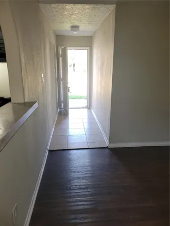 a view of hallway with wooden floor