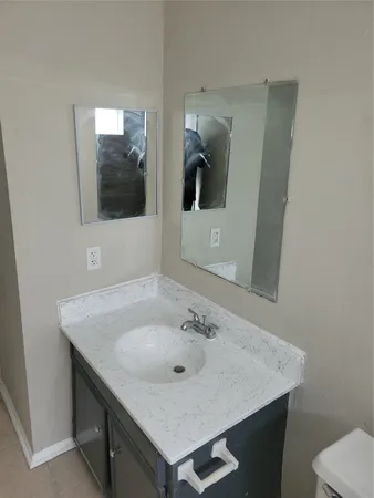 a bathroom with a sink and mirror