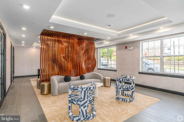 a living room with furniture and a large window