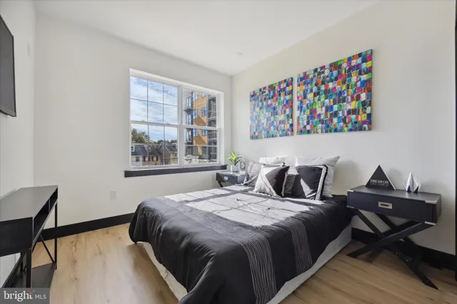 a bed sitting in a bedroom next to a window
