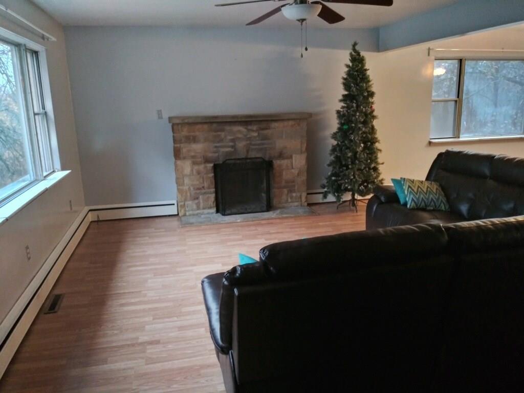105 Evans City Road Butler, PA 16001 - Photo 4 of 25 Newer flooring and stone fireplace on tenant side of house.