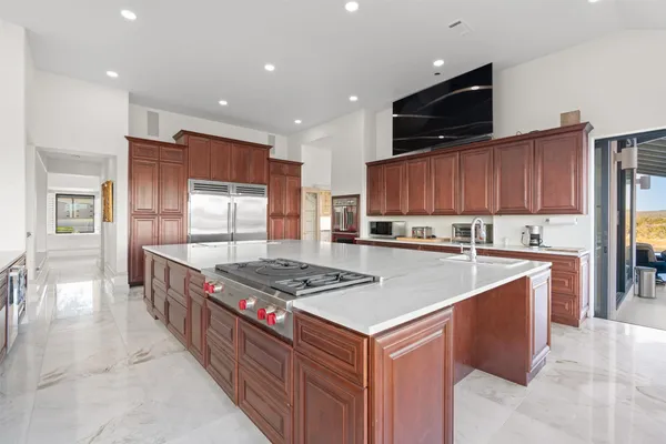 a kitchen with stainless steel appliances granite countertop a stove a sink and a microwave