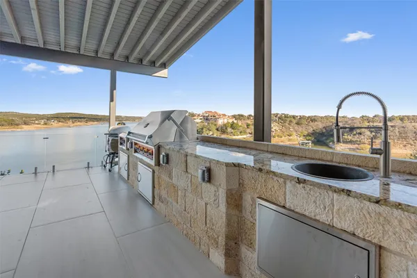a view of a kitchen with a sink and cabinets