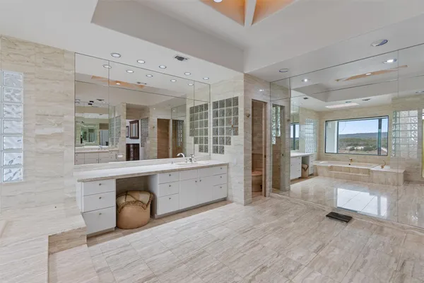 a large white kitchen with a large window