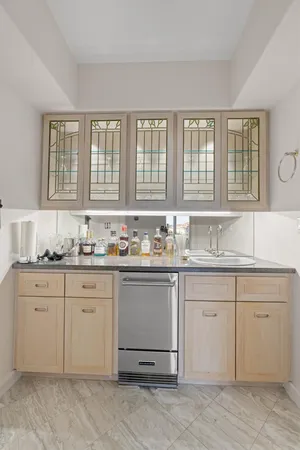 a bathroom with a granite countertop sink and a large mirror
