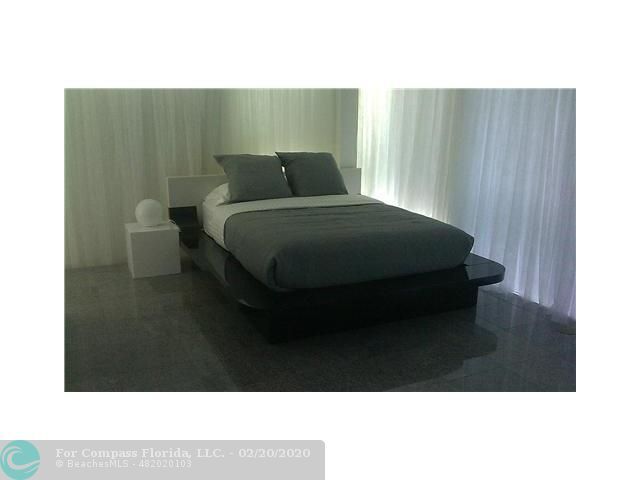 a kitchen with stainless steel appliances granite countertop a stove a sink and a dining table view