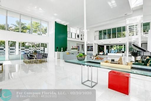 a living room with furniture and large windows