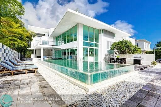 a bedroom with a bed couch and large window