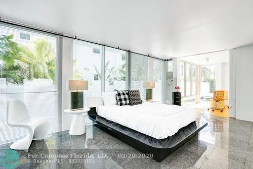 a living room with furniture and large windows