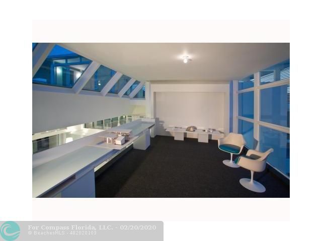 a view of a living room with a sink and a large window with backyard