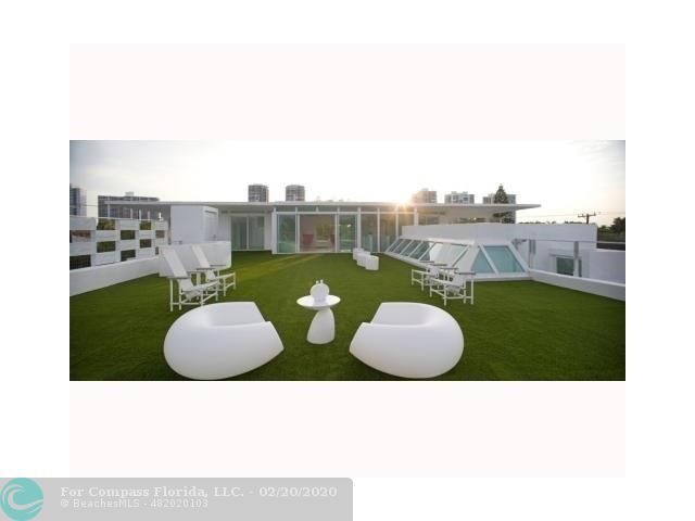 a view of a living room with a floor to ceiling window