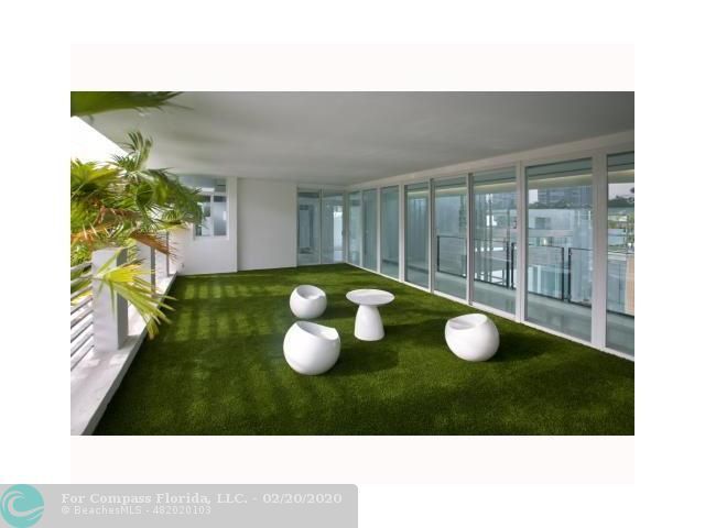 a living room with a couch and a large window