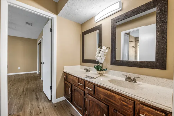 a bathroom with a granite countertop sink and a mirror