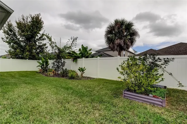 a living room with furniture or chandelier and a wooden floor