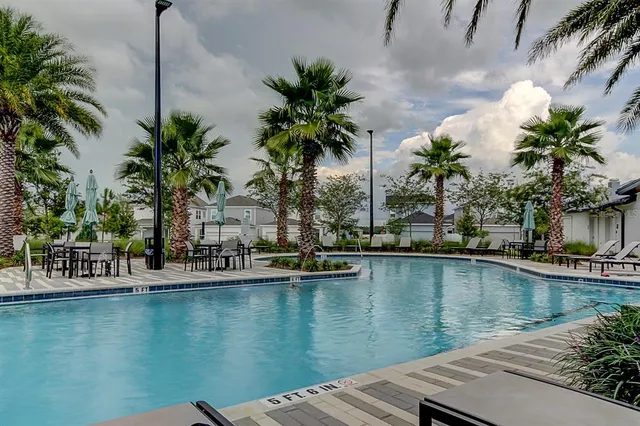 a living room with furniture and large windows