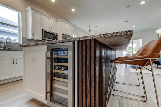 a kitchen with granite countertop a stove sink and cabinets