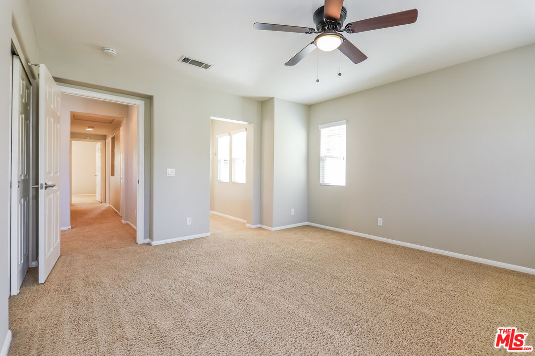 3 Wood Barn Road Ladera Ranch, CA 92694 - Photo 16 of 27 an empty room with chandelier fan and windows