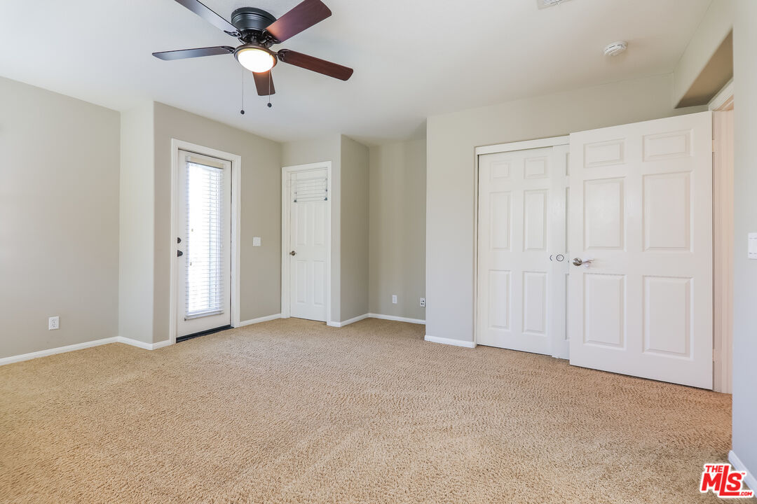 3 Wood Barn Road Ladera Ranch, CA 92694 - Photo 18 of 27 an empty room with closet and a chandelier fan