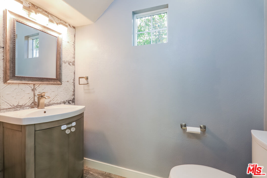 3 Wood Barn Road Ladera Ranch, CA 92694 - Photo 25 of 27 a bathroom with a sink mirror vanity and a toilet