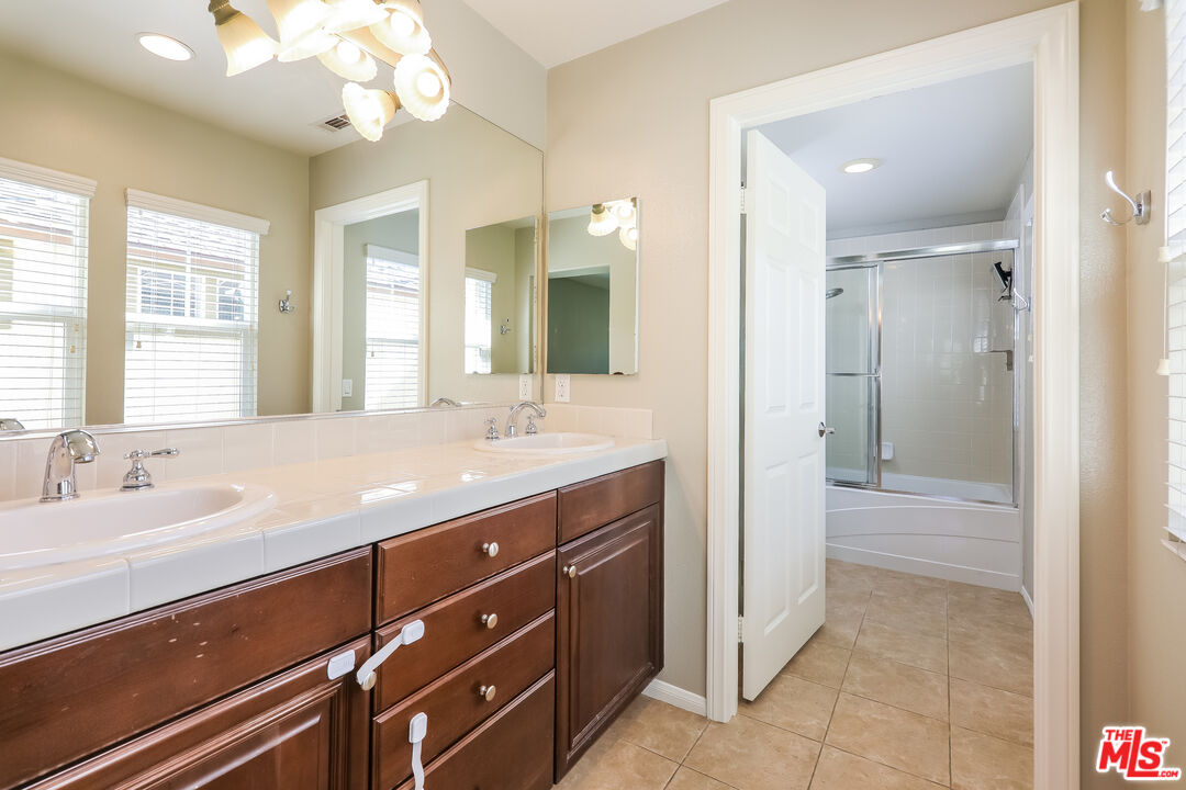 3 Wood Barn Road Ladera Ranch, CA 92694 - Photo 7 of 27 a spacious bathroom with a granite countertop sink a mirror and a shower