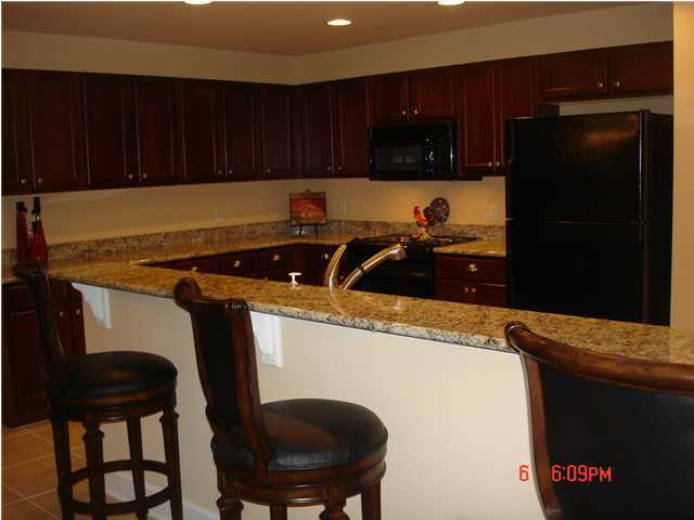 1732 Hwy Santa Rosa Beach, Unit 403 30A Santa Rosa Beach, FL 32459 - Photo 3 of 15 a kitchen with a sink a stove and cabinets