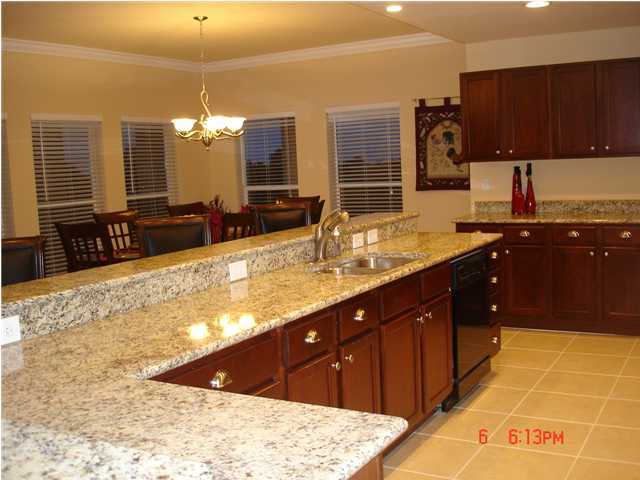 1732 Hwy Santa Rosa Beach, Unit 403 30A Santa Rosa Beach, FL 32459 - Photo 4 of 15 a large kitchen with granite countertop a sink and a stove