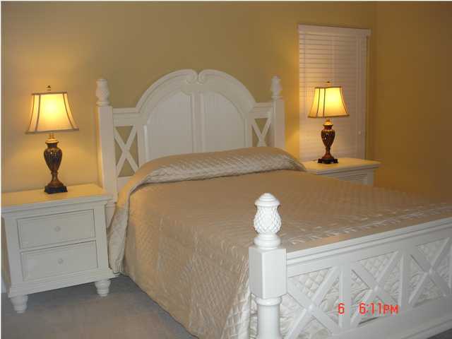 1732 Hwy Santa Rosa Beach, Unit 403 30A Santa Rosa Beach, FL 32459 - Photo 9 of 15 a bedroom with a bed and a chandelier