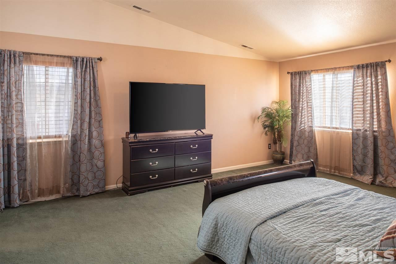 18205 Fontana Court Reno, NV 89508 - Photo 14 of 27 a bedroom with a bed and a flat screen tv
