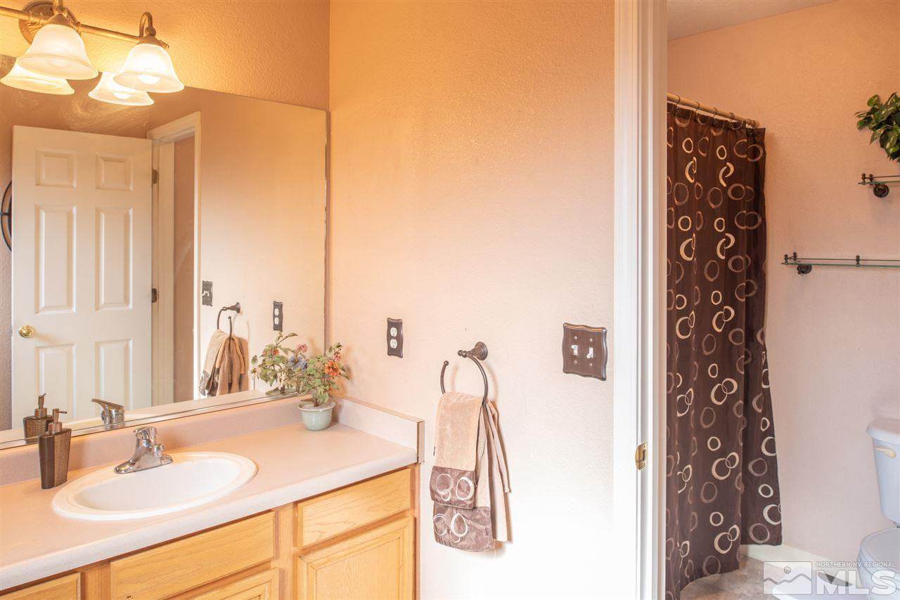 18205 Fontana Court Reno, NV 89508 - Photo 16 of 27 a bathroom with a sink vanity and a mirror