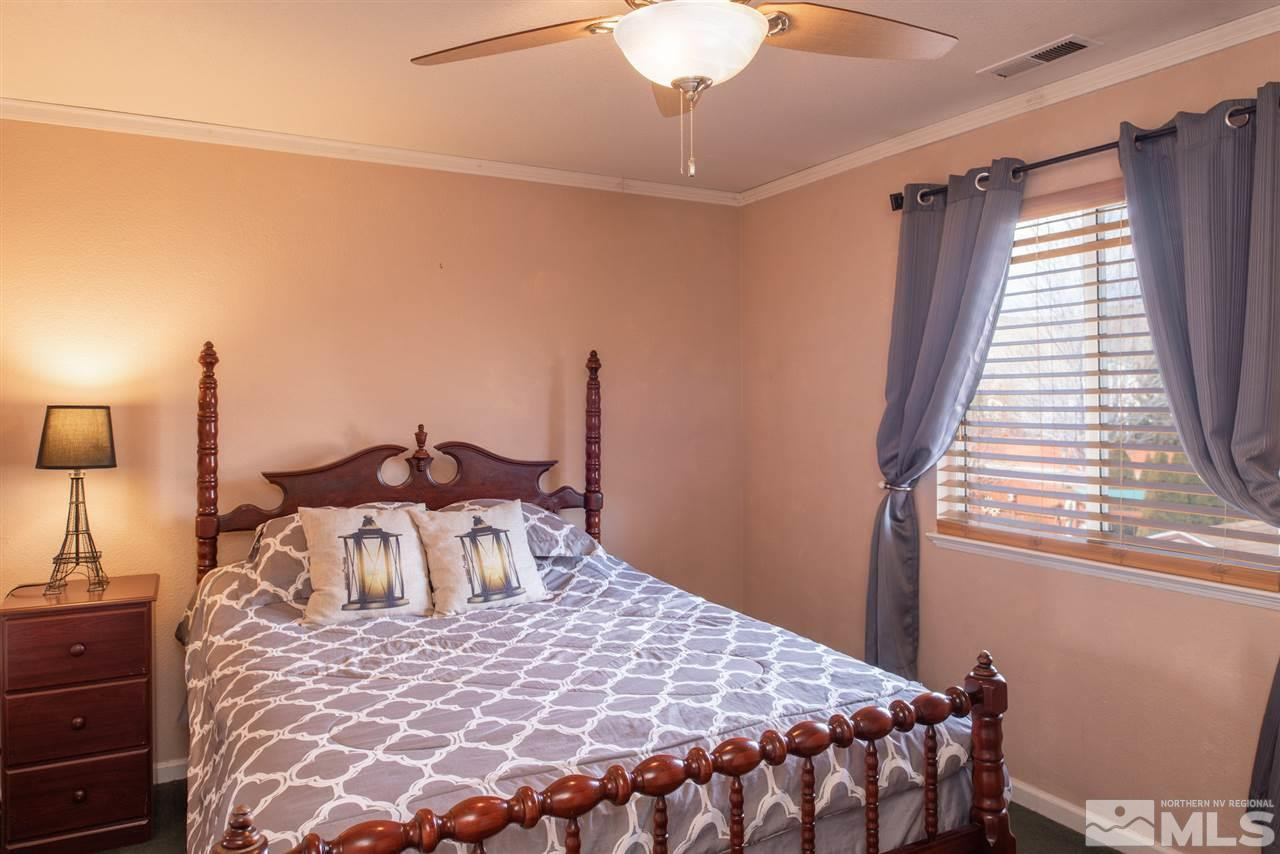 18205 Fontana Court Reno, NV 89508 - Photo 19 of 27 a bedroom with a bed and wooden floor