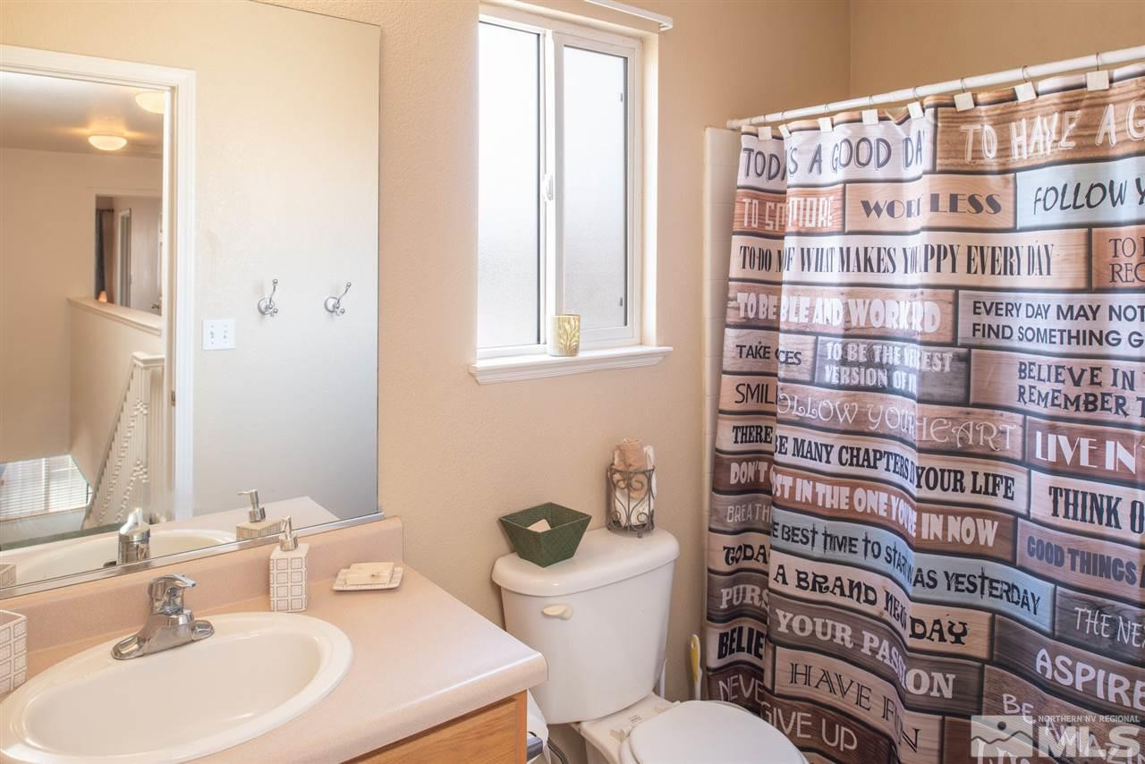 18205 Fontana Court Reno, NV 89508 - Photo 20 of 27 a bathroom with a sink a toilet and a mirror