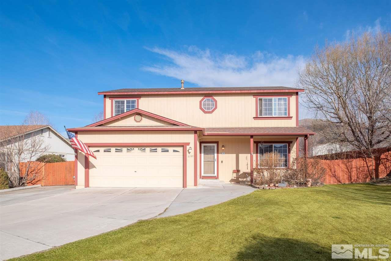 18205 Fontana Court Reno, NV 89508 - Photo 2 of 27 a front view of a house with a yard and garage
