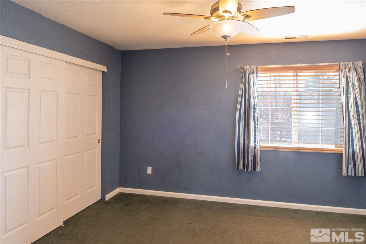 18205 Fontana Court Reno, NV 89508 - Photo 22 of 27 an empty room with a window and a ceiling fan