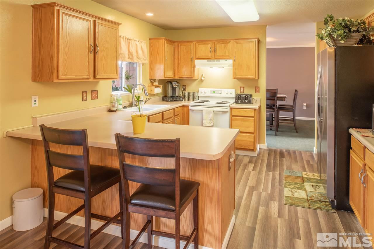 18205 Fontana Court Reno, NV 89508 - Photo 9 of 27 a dining hall with stainless steel appliances a dining table and chairs