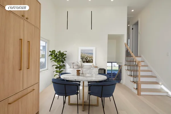 a dining room with furniture and wooden floor