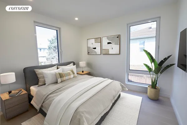 a bedroom with bed and a potted plant