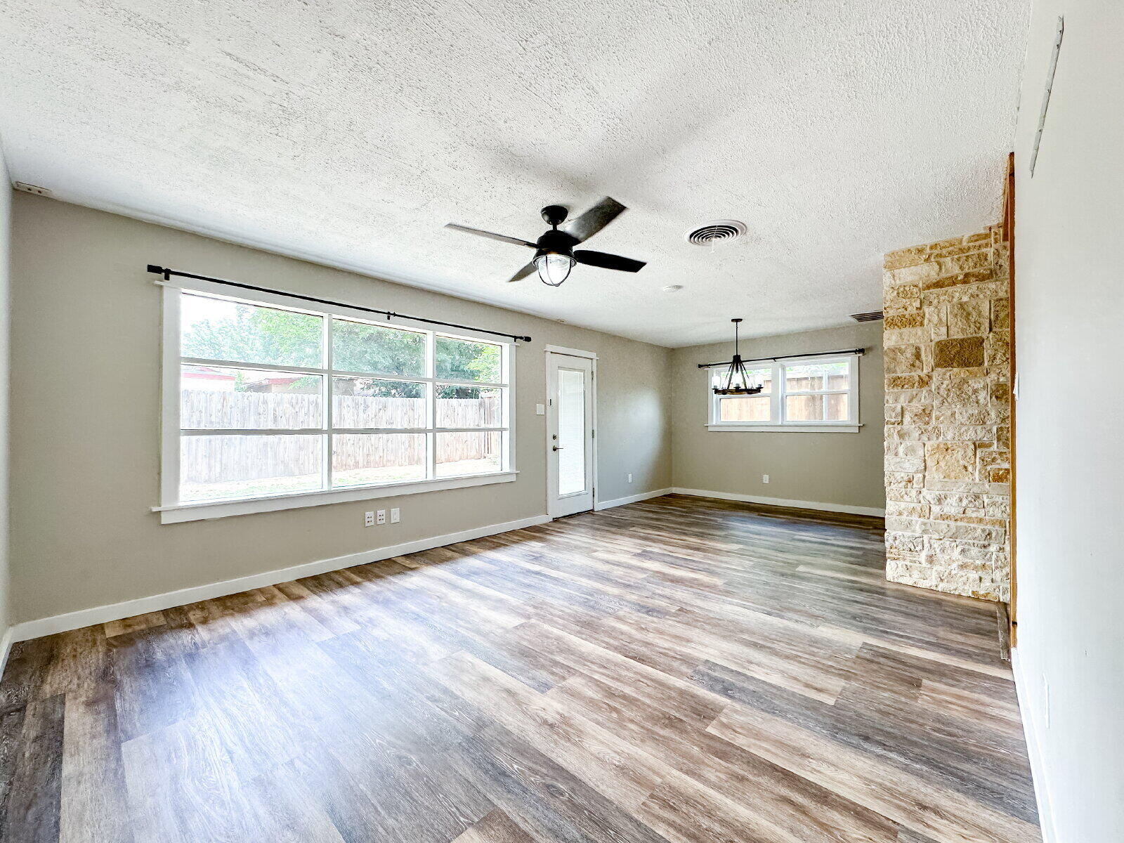 2608 Raleigh Avenue Lubbock, TX 79410 - Photo 20 of 23 a view of empty room with wooden floor and fan