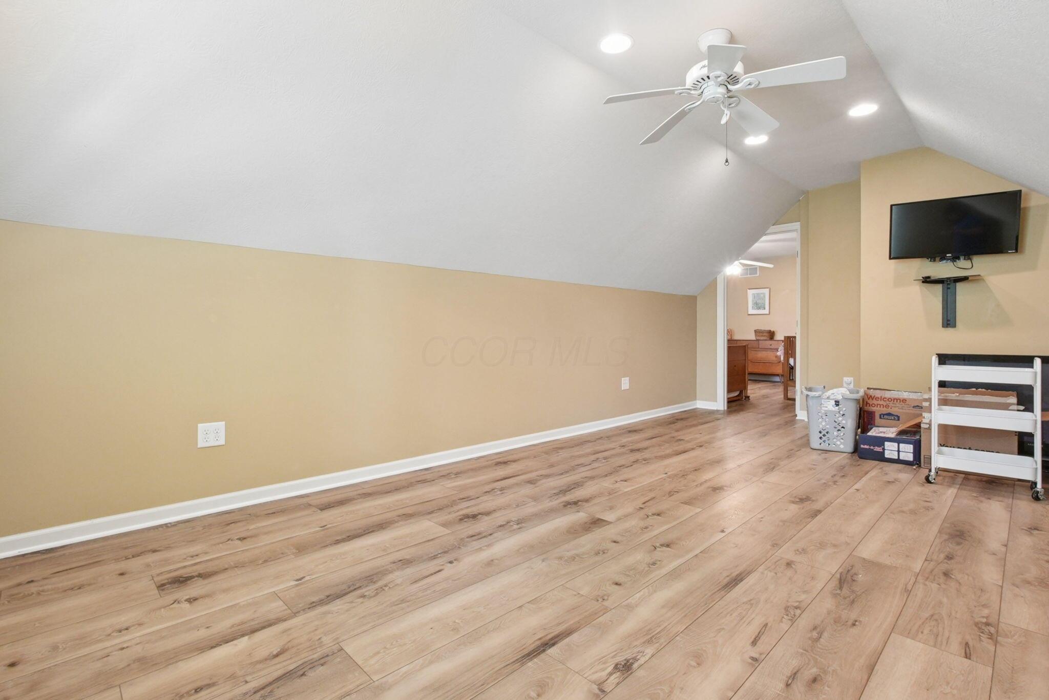 9435 Concord Road Powell, OH 43065 - Photo 40 of 77 Wood-finish flooring with recessed lighting and a ceiling fan